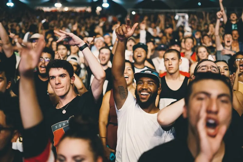 Live music concert crowd with dramatic stage lighting at night