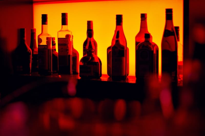 European-style wine bar with warm lighting and shelves of bottles