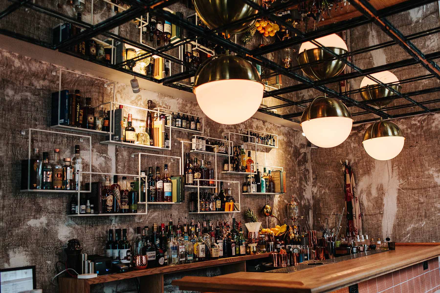 The gold-lit Gift Shop cocktail room behind Barber & Co on Ossington