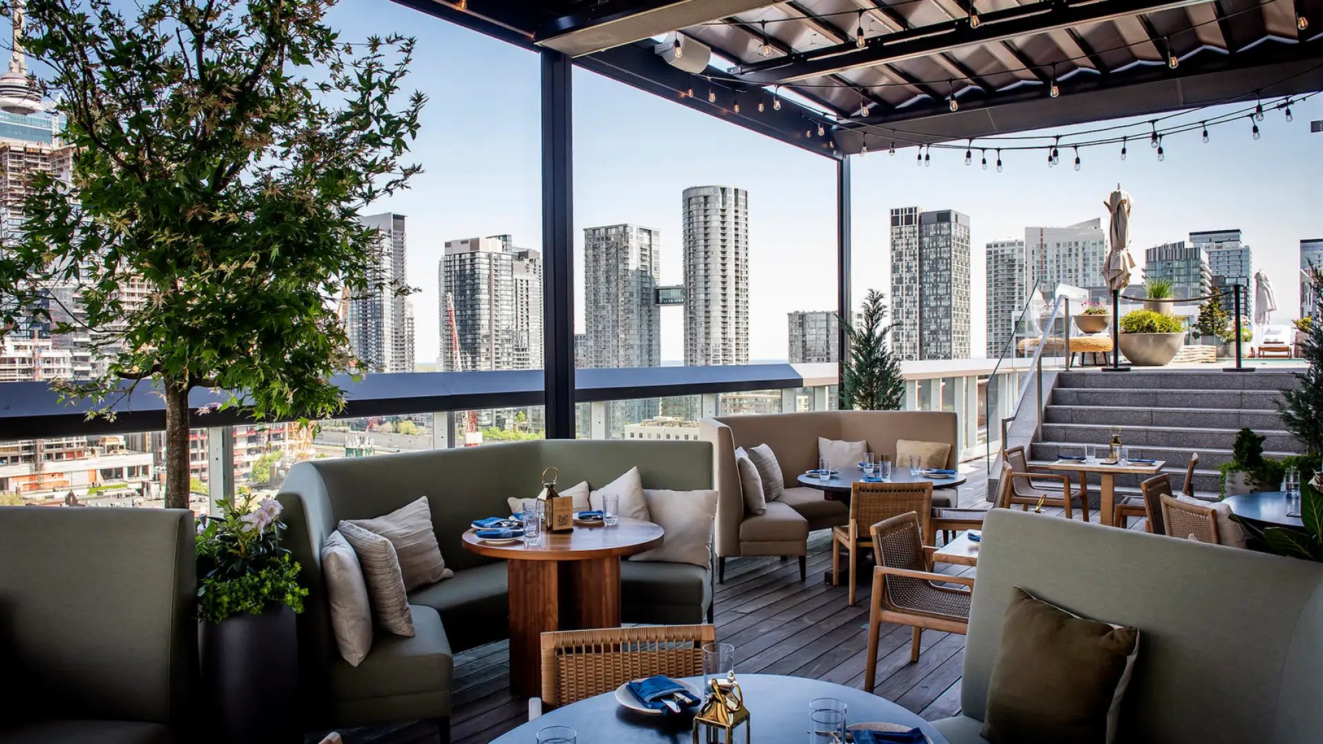 Covered lounge seating at Harriet’s Rooftop in Toronto