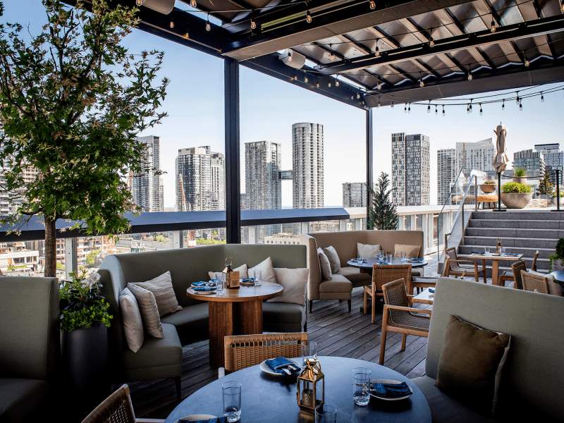 Covered lounge seating at Harriet’s Rooftop in Toronto