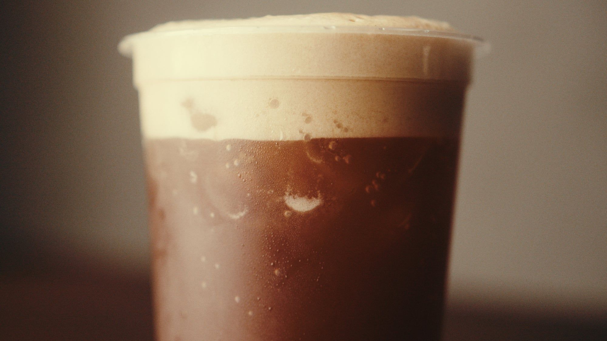 Signature iced coffee with charcoal foam at KAFE 002 on Queen West