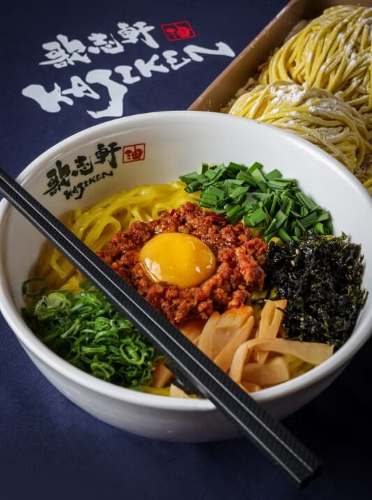 Official Kajiken Homura-style abura soba bowl with egg yolk, minced pork, nori, and chopsticks, from kajiken.ca