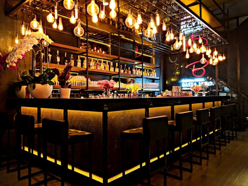 Retro-styled cocktail lounge with vintage diner seating and moody lighting