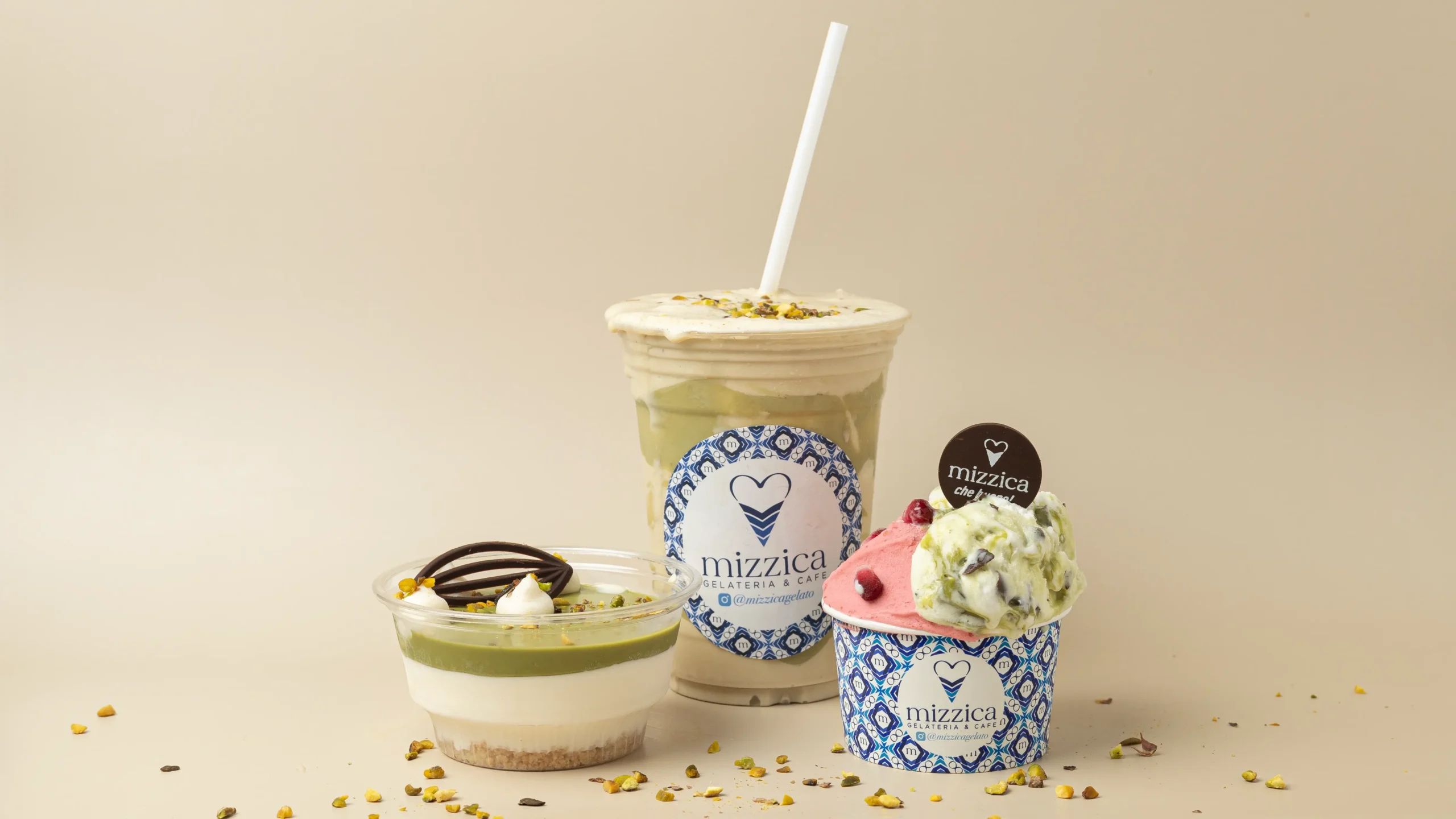 The bright blue and white interior of Mizzica Gelateria & Cafe featuring gelato display cases.
