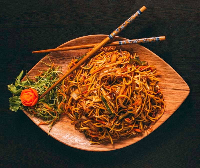 Vibrant Indonesian dishes with sambal condiments on a rustic table
