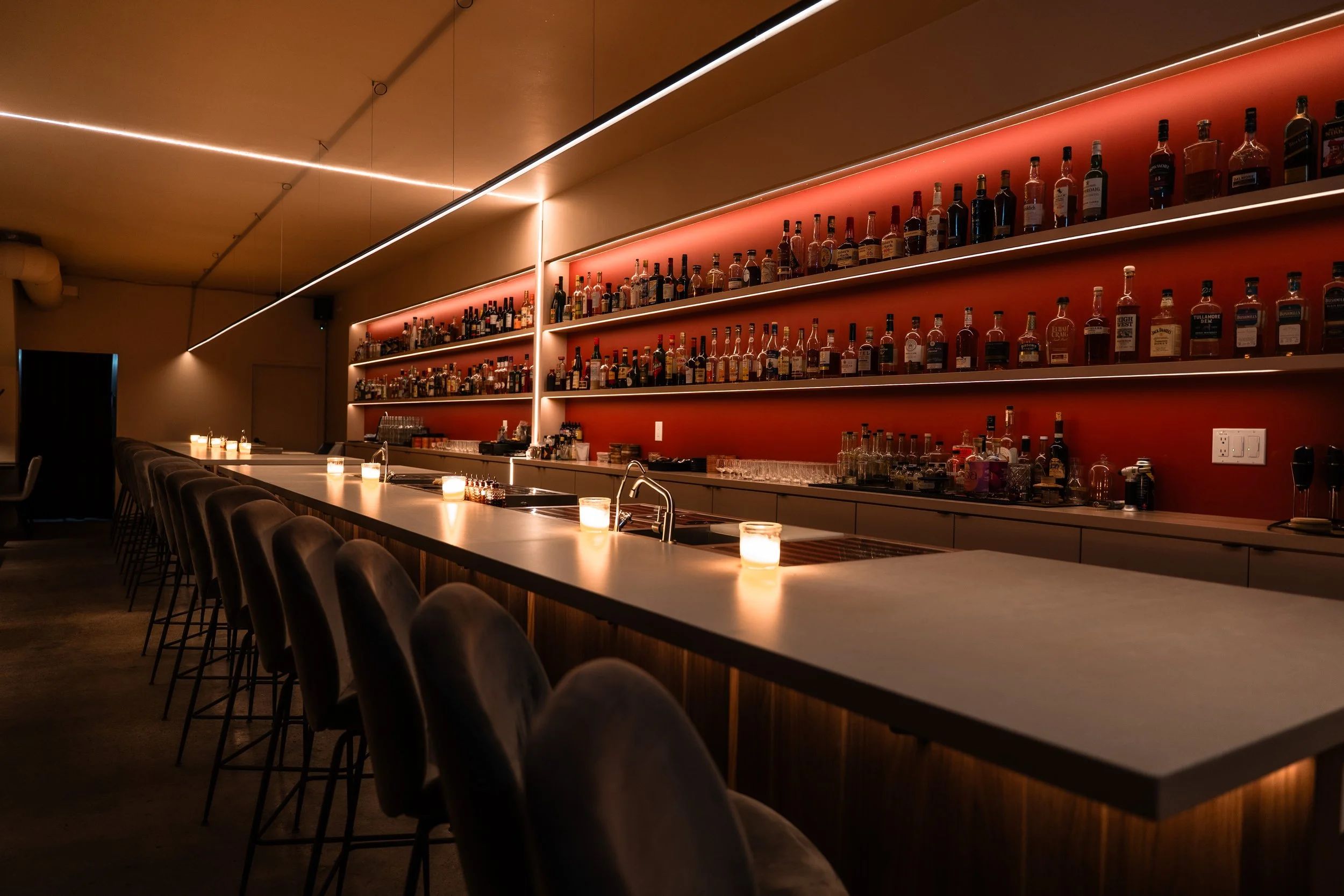 The long bar inside Suite 115, Little Italy’s keypad speakeasy