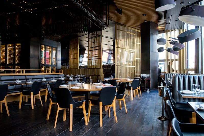 Warm historic dining room with leather banquettes and brass fixtures