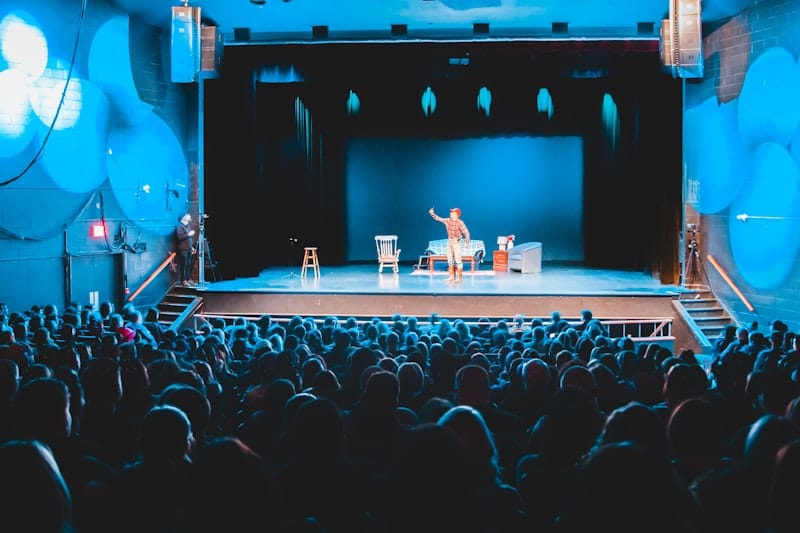A spotlight illuminating a microphone stand on an empty stage