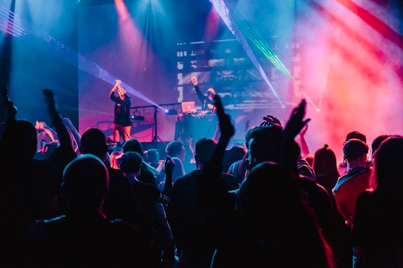 Vocal performers on stage with dramatic spotlight in concert hall